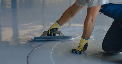 person applying an epoxy coating